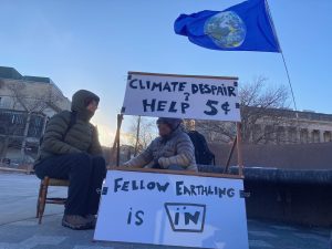 Person visits a booth offering help for climate despair.